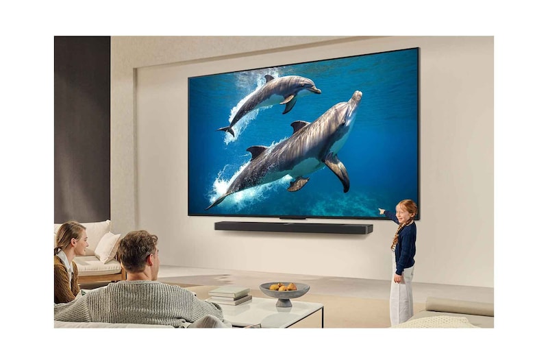 Sci-fi content is playing on an LG TV screen. On the screen is the Al Chatbot interface. The user messaged the chatbot saying that the screen is too dark. The chatbot offered solutions to the request. The whole scene is also split in two. One side is darker, the other side is brighter, showing how Al Chatbot solved the issue for the user automatically. Text explains Al Chatbot can understand user intent and provide solutions to troubleshoot.